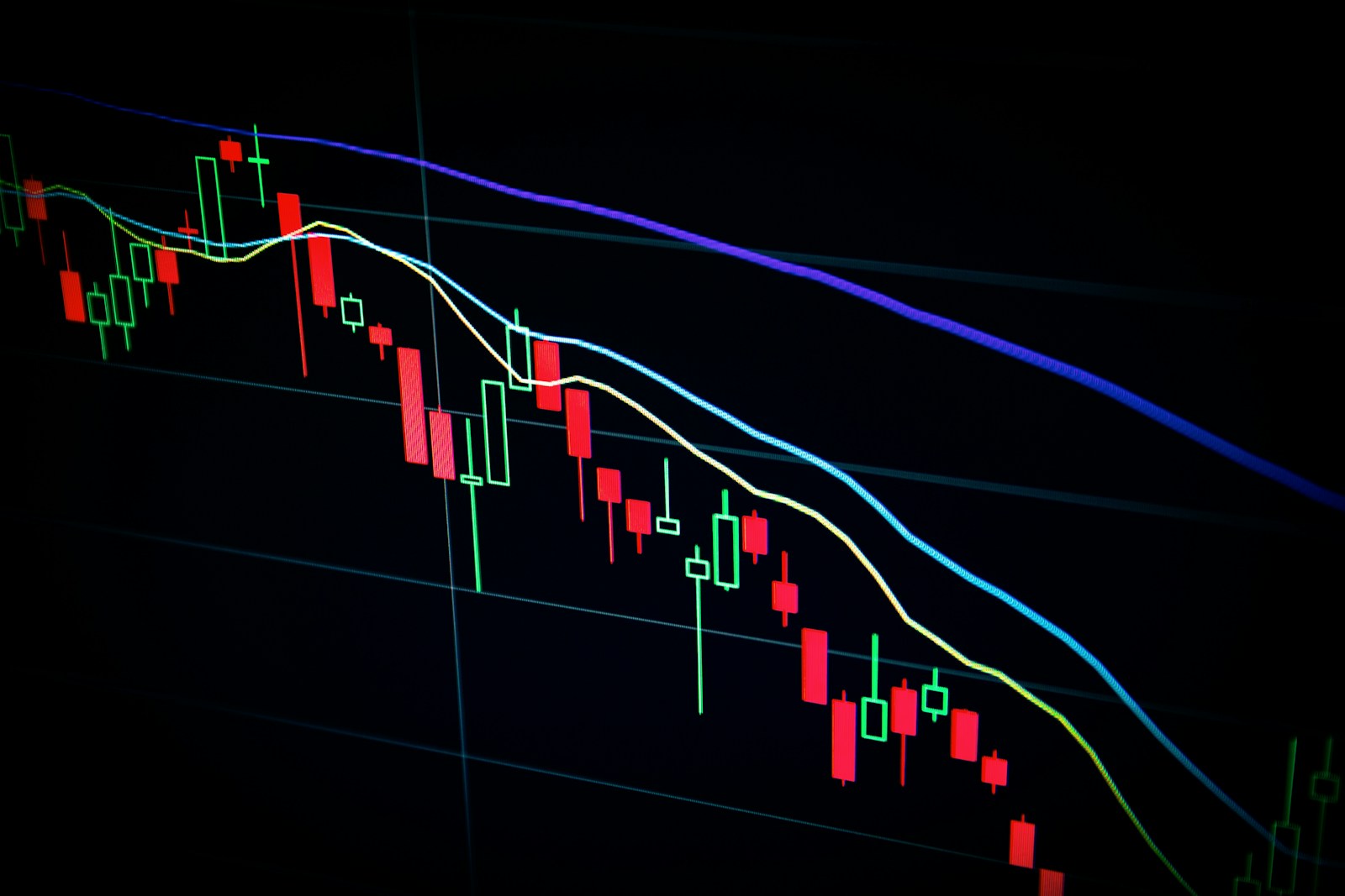 Technology desk monitors showing semiconductor supply wire headlines